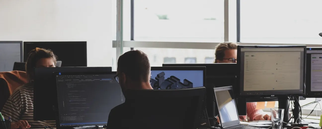 peple sitting on chairs in front of computers
