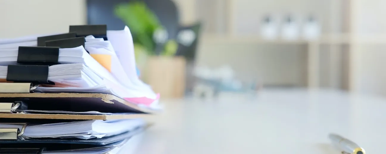 stack of paper files on desk