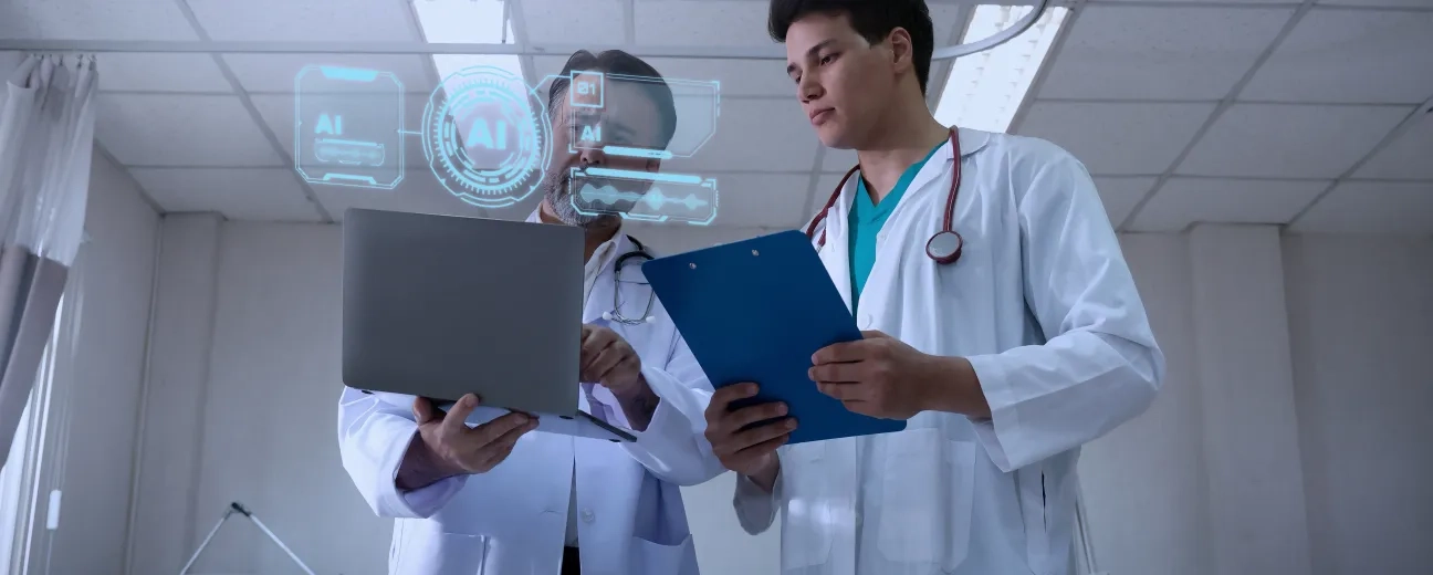Two healthcare professionals reviewing patient data on a laptop with AI interface overlays in a clinical setting.