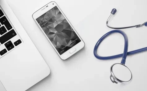 stethoscope near laptop and mobile phone