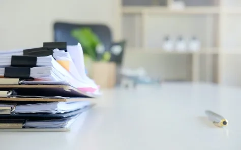 stack of paper files on desk