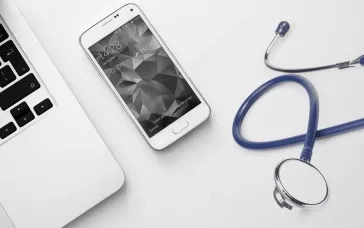 stethoscope near laptop and mobile phone