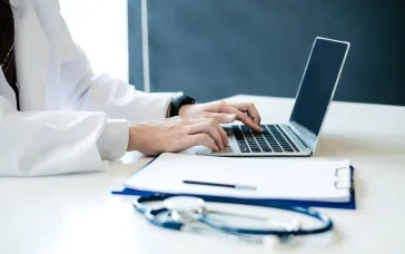 person typing at laptop 